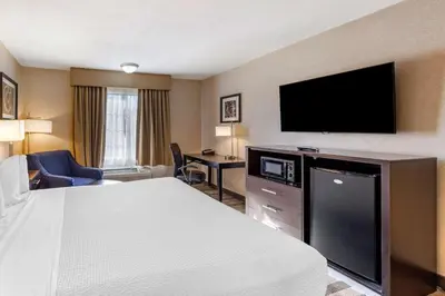 a hotel room with a bed and a flat screen tv at Best Western Country Inn Temecula in Temecula