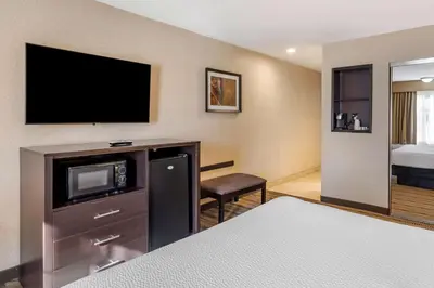 a hotel room with a bed and a flat screen tv at Best Western Country Inn Temecula in Temecula