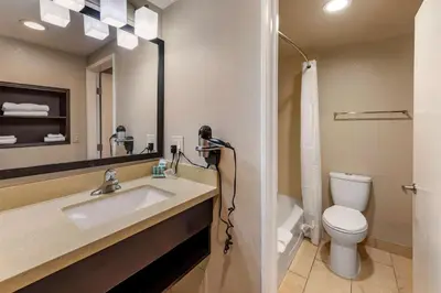 a bathroom with a sink and a toilet and a mirror at Best Western Country Inn Temecula in Temecula