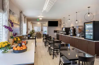 a restaurant with tables and chairs and a bar at Best Western Country Inn Temecula in Temecula