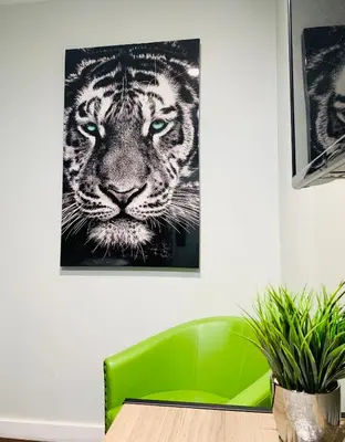 a room with a green chair and a tiger painting at Villa Serena in El Cajon