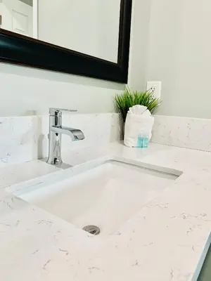 a white sink in a bathroom with a mirror at Villa Serena in El Cajon