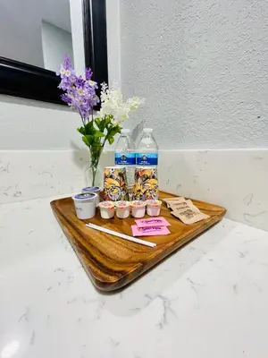 a tray with food and a bottle of water and flowers at Villa Serena in El Cajon