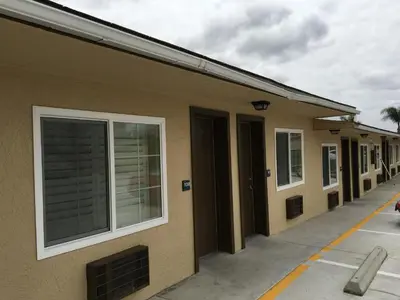 a row of houses with windows on a street at Ace Budget Motel in San Diego