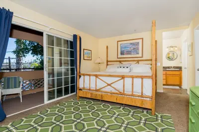 a bedroom with a bed and a balcony at Rooftop Deck Spectacular Ocean View M-A in Oceanside