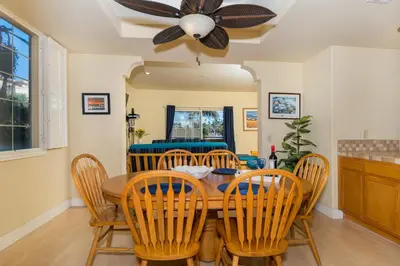 a dining room with a wooden table and chairs at Rooftop Deck Spectacular Ocean View M-A in Oceanside
