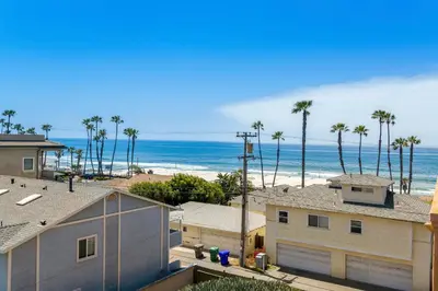 a view of a beach with palm trees and houses at Rooftop Deck Spectacular Ocean View M-A in Oceanside