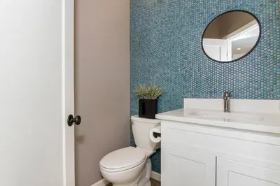 a bathroom with a toilet and a sink and a mirror at Ocean View Steps to Beach M-C in Oceanside
