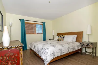 a bedroom with a bed and a window at Ocean View Steps to Beach M-C in Oceanside