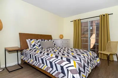 a bedroom with a bed and a window at Ocean View Steps to Beach M-C in Oceanside