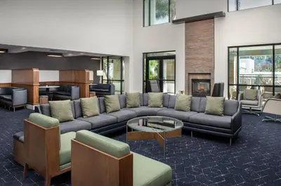 a living room with a couch and a fireplace at Courtyard by Marriott San Diego Carlsbad in Carlsbad