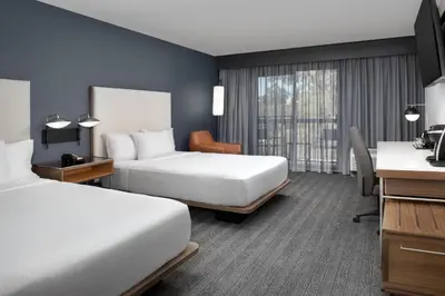 a hotel room with two beds and a desk at Courtyard by Marriott San Diego Carlsbad in Carlsbad