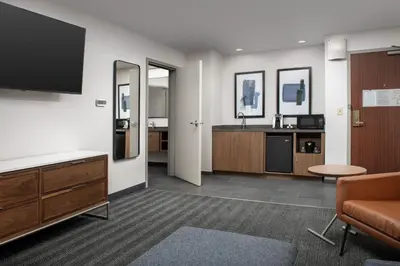 a living room with a tv and a couch at Courtyard by Marriott San Diego Carlsbad in Carlsbad