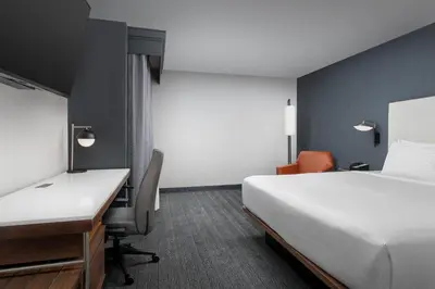 a hotel room with a bed and a desk and a computer at Courtyard by Marriott San Diego Carlsbad in Carlsbad