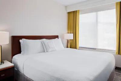 a bed in a hotel room with a large window at SpringHill Suites San Diego Rancho Bernardo/Scripps Poway in Poway
