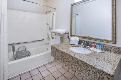 a bathroom with a sink and a shower and a mirror at Super 8 by Wyndham San Diego Hotel Circle in San Diego