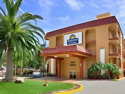 a hotel with a palm tree in front of it at Days Inn by Wyndham Mission Valley-SDSU in San Diego