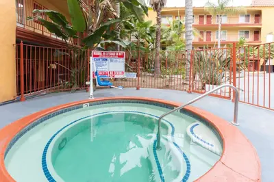 a swimming pool with a hot tub in a building at Days Inn by Wyndham Mission Valley-SDSU in San Diego
