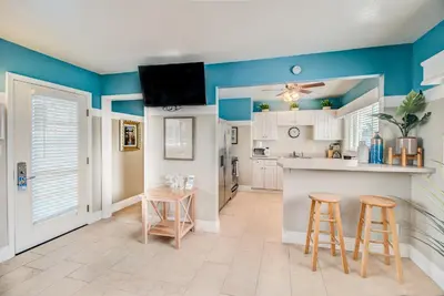 a kitchen with blue walls and two bar stools at The Inn at Sunset Cliffs in San Diego