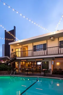 a hotel with a swimming pool in front of a building at The Pearl Hotel in San Diego