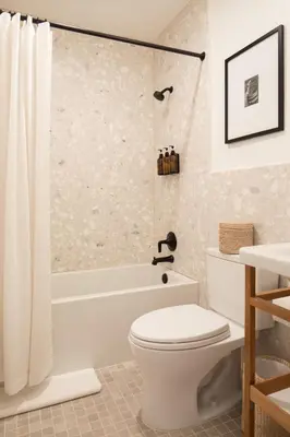 a bathroom with a white toilet and a bath tub at The Pearl Hotel in San Diego