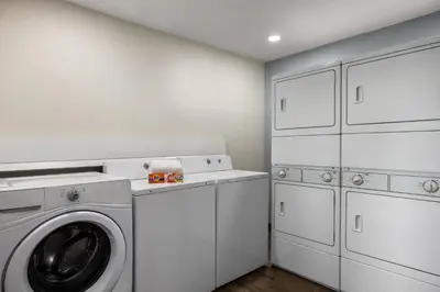 a white laundry room with a washer and dryer at Candlewood Suites San Diego by IHG in San Diego