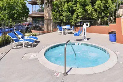 a small pool with chairs and a table and chairs at Candlewood Suites San Diego by IHG in San Diego