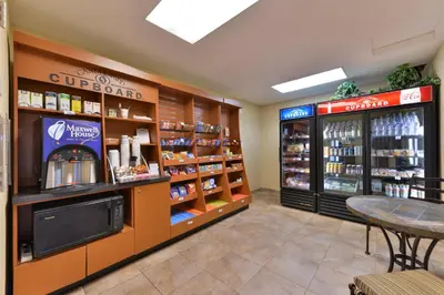 a restaurant with a coffee shop with a table and a counter at Candlewood Suites San Diego by IHG in San Diego