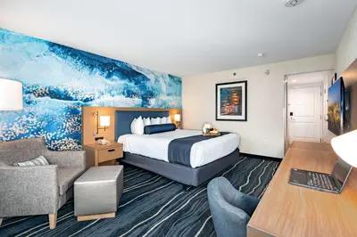 a hotel room with a king sized bed and a desk at Best Western Plus Marina Gateway Hotel in National City