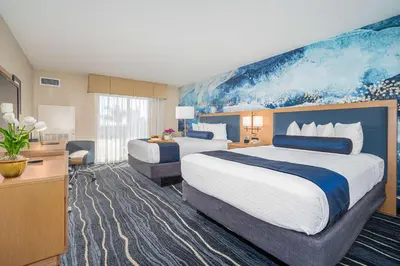 a hotel room with two beds and a painting on the wall at Best Western Plus Marina Gateway Hotel in National City