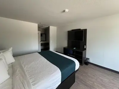 a hotel room with a bed and a flat screen tv at Motel 6 Lake Elsinore, CA in Lake Elsinore