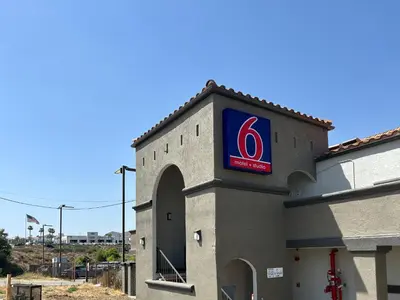 a pepsi sign on the side of a building at Motel 6 Lake Elsinore, CA in Lake Elsinore