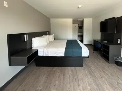 a hotel room with a bed and a desk at Motel 6 Lake Elsinore, CA in Lake Elsinore