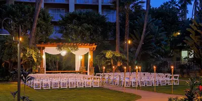 a group of white chairs in front of a building at Crowne Plaza San Diego - Mission Valley by IHG in San Diego