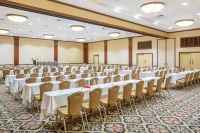 a large banquet hall with white tables and chairs at Crowne Plaza San Diego - Mission Valley by IHG in San Diego