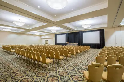 an empty conference room with chairs and a stage at Crowne Plaza San Diego - Mission Valley by IHG in San Diego
