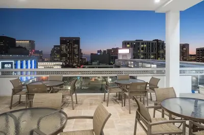 a balcony with tables and chairs and a city skyline at Holiday Inn Express - Downtown San Diego by IHG in San Diego