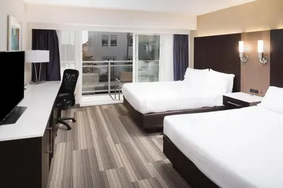 a hotel room with two beds and a balcony at Holiday Inn Express - Downtown San Diego by IHG in San Diego