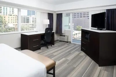 a hotel room with a bed and a desk with a television at Holiday Inn Express - Downtown San Diego by IHG in San Diego