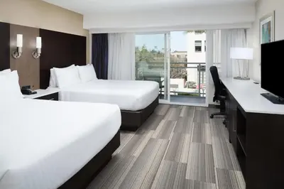 a hotel room with two beds and a desk at Holiday Inn Express - Downtown San Diego by IHG in San Diego