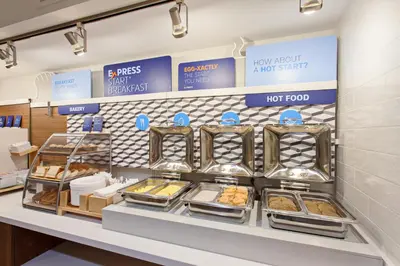 a bakery with trays of pastries on a shelf at Holiday Inn Express Mira Mesa San Diego by IHG in Mira Mesa