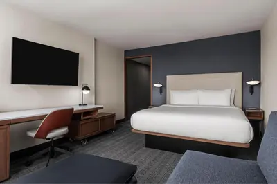 a hotel room with a bed and a desk and chair at Courtyard by Marriott San Diego Miramar in San Diego