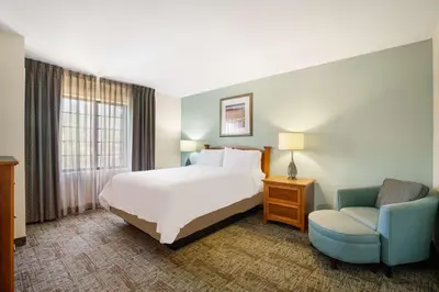 a hotel room with a bed and a chair at Sonesta ES Suites San Diego - Rancho Bernardo in Rancho Bernardo