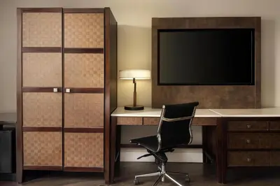 a room with a desk and a television and a chair at The DEXTRO Little Italy, BW Premier Collection in San Diego