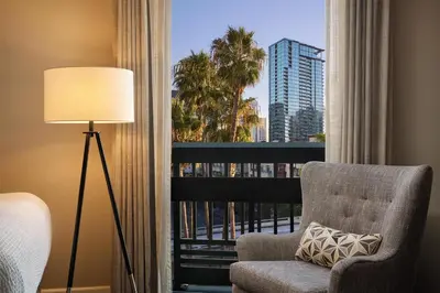 a room with a chair and a window with a view at The DEXTRO Little Italy, BW Premier Collection in San Diego