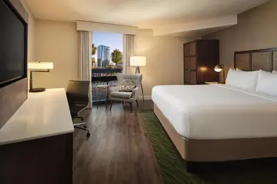 a hotel room with a bed and a chair at The DEXTRO Little Italy, BW Premier Collection in San Diego
