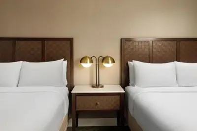 two beds sitting next to each other in a hotel room at The DEXTRO Little Italy, BW Premier Collection in San Diego