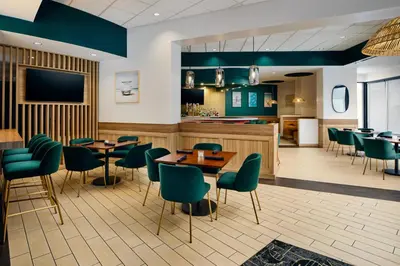 a restaurant with tables and chairs and a bar at The DEXTRO Little Italy, BW Premier Collection in San Diego