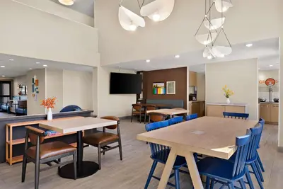 a conference room with tables and chairs and a tv at Sonesta ES Suites San Diego - Sorrento Mesa in Sorrento