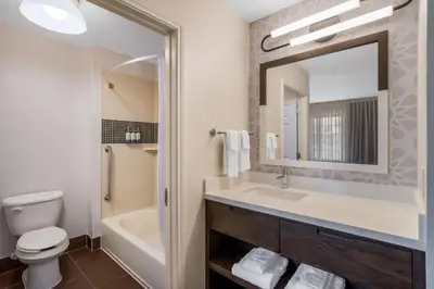a bathroom with a sink and a toilet and a mirror at Sonesta ES Suites San Diego - Sorrento Mesa in Sorrento